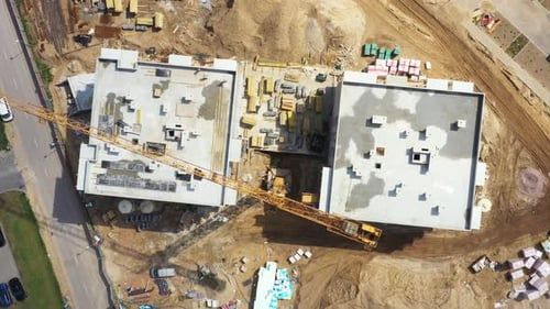 Aerial Flight Over a New Constructions Development Site with High Tower Cranes Building Real Estate.