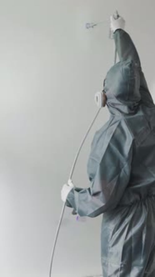 Worker Paint a Wall with White Airless Paint Airless Spray Painting Home Renovation A Professional
