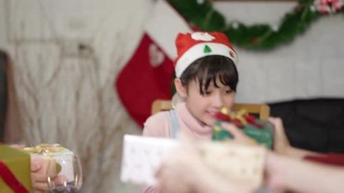 Excited Girl Receiving Christmas Gifts at Home