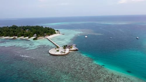 Aerial view of beautiful maldives island water villa bungalows in turquoise lagoon near the white sa