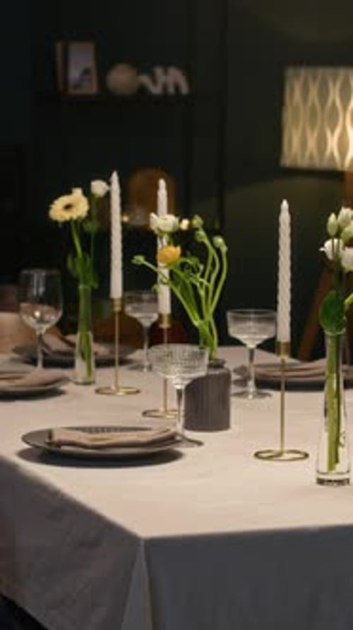 Dining Table Decorated with Flowers and Candles for Holiday Celebration at Home