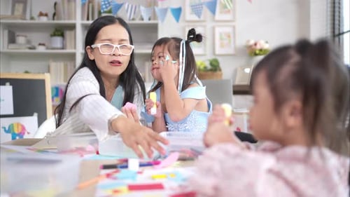 Woman and Children Creating Art Together Indoors