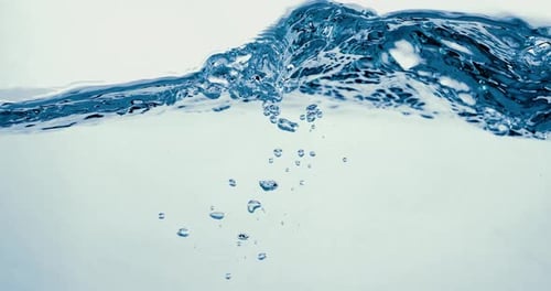 Many bubbles in water close up, abstract water wave with bubbles in slow motion