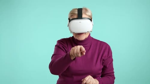 Senior Woman Experiencing Virtual Reality with Headset