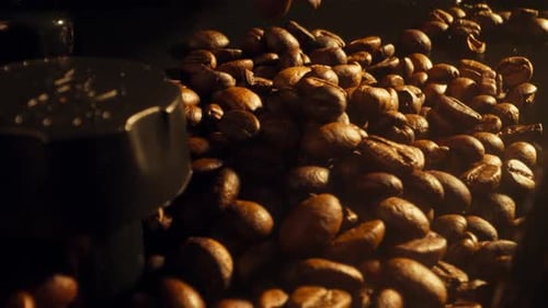 Dolly in shot of coffee beans pouring down on a coffee