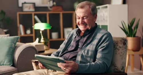Smiling Senior Man Using Tablet at Home