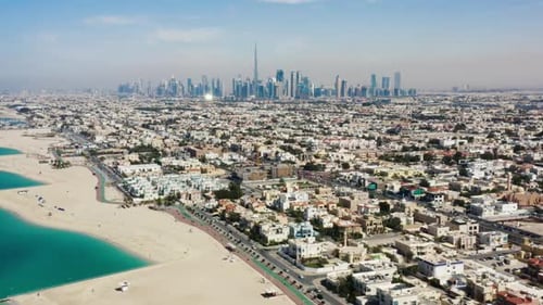 Drone video of Dubai city at day time, modern city concept with water and transport.