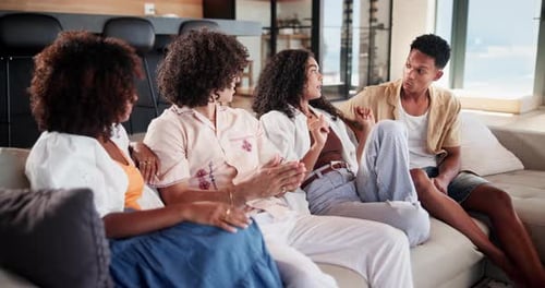 Friends Chatting on a Couch in Bright Living Room