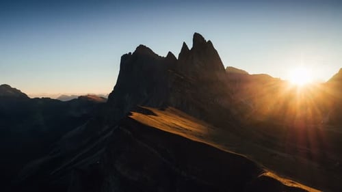Darkened brown colored hill. Beautiful sunset in the Italian majestic Seceda dolomite mountains