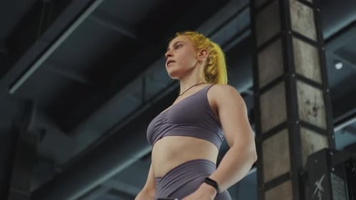 Gorgeous Female Professional Bodybuilder Doing Workout Exercises in Gym