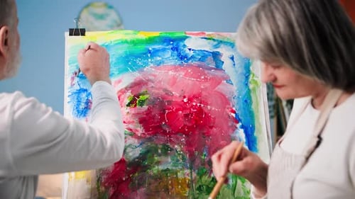 Senior Couple Painting Together at Easel