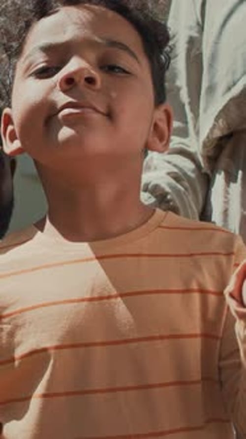 Boy Smiles and Waves American Flag Portrait