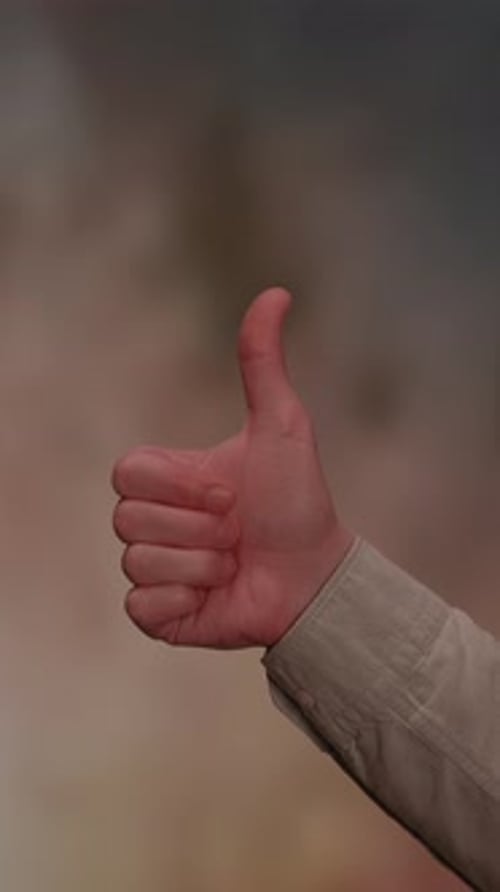 Hand Gesturing Thumbs Up and Thumbs Down