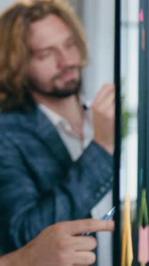 Attractive Hardworking Adept Businessman and Woman Teammates Standing Near Office Glass Wall and