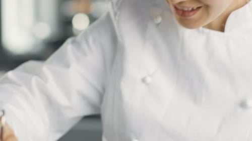 Woman Chef Glazing Fresh Croissants in Kitchen