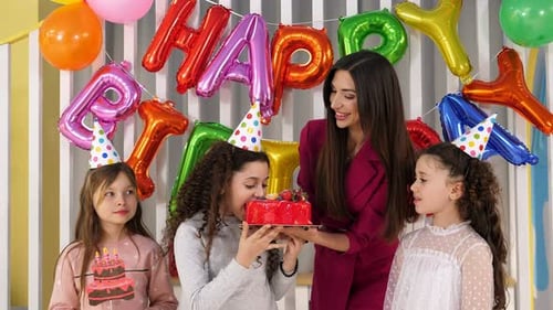Girls Celebrate Birthday with Cake and Balloons