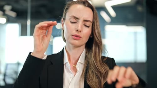 Professional Businesswoman Suffering From Headache in Office