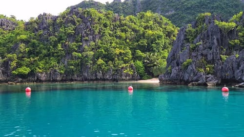 Turquoise Tropical Lagoon on Exotic Island Under Steep Limestone Cliffs and Hills