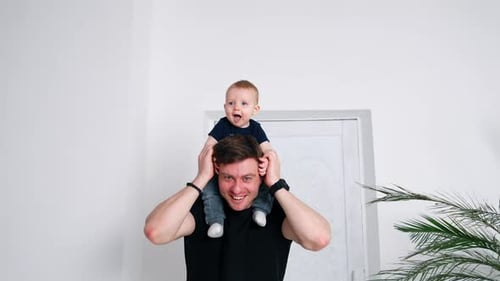 Father and Infant Smiling Indoors