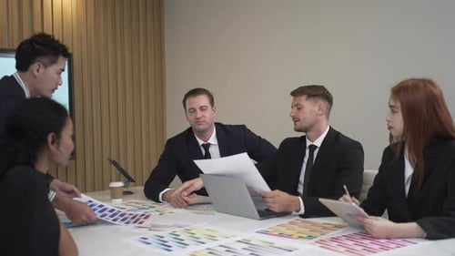 Diverse Business Team Collaborating on Project in Modern Office