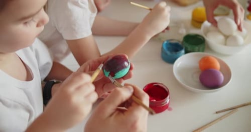 Joyful Family Painting Easter Eggs Together in Bright Modern Kitchen Closeup