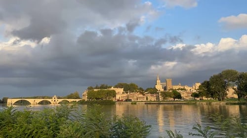 Timelapse of Avignon in France before sunset. Touristic City with traffic and bridge.