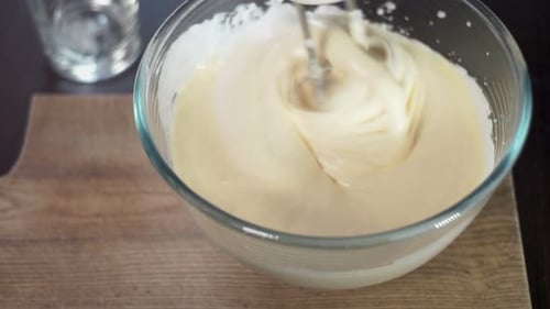 Mixing dough in glass bowl with motor mixer for sweet homemade food preparation