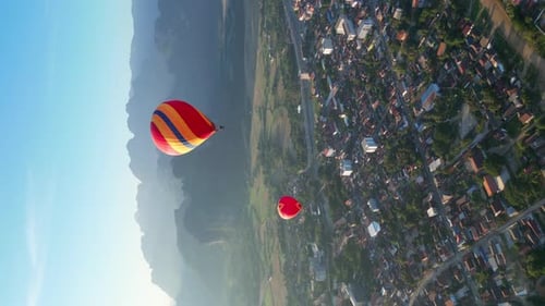 Hot air balloon epic flying above mountain over the fog at sunrise with beautiful sky