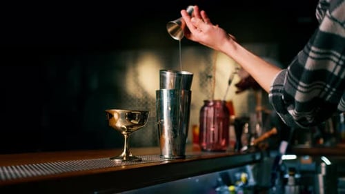 professional bartender creating a cocktail drink Experienced bartender pours an alcoholic drink