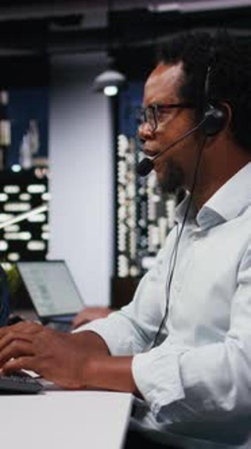 Vertical Video Startup Helpdesk System Administrator in Office Speaking in Headset Mic