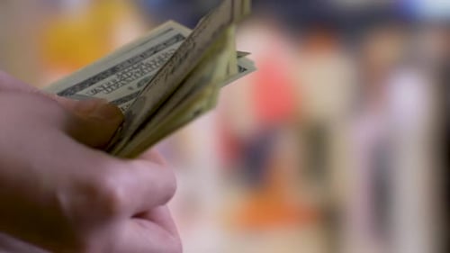 Hands Counting One Hundred Dollar Bills Close Up