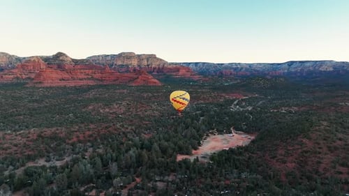 Sedona Forests And Canyons With Flying Hot Air Balloon During Sunrise In Arizona, USA. Aerial Wide S