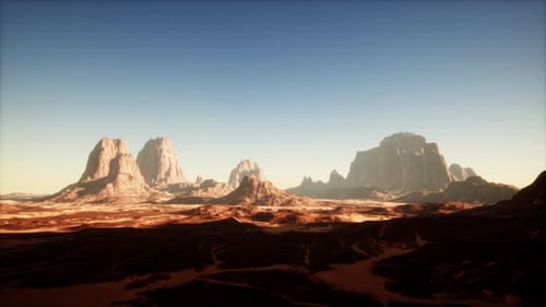 Exploring Majestic Red Rock Formations Under A Clear Desert Sky