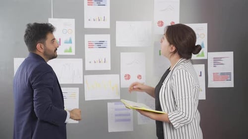 Business Team Analyzing Data Charts in Modern Office