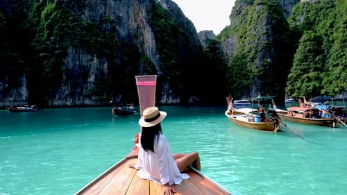 Asian Women in Front of a Longtail Boat at Koh Phi Phi Island Thailand Pileh Lagoon