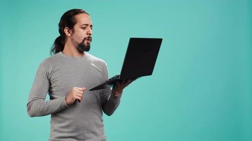 Man Composing Email Typing on Laptop Keyboard Excited to Log Off After Work
