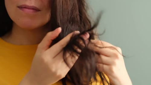 Closeup Female Holding Messy Hair in Hands