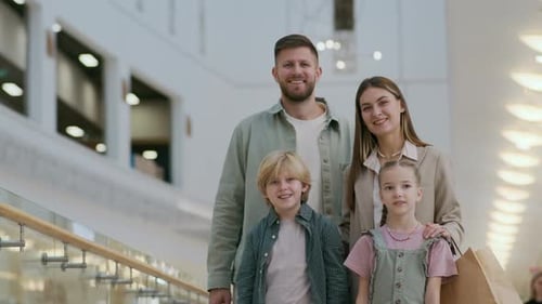 Portrait of Spouses and Their Kids Going Shopping in Mall