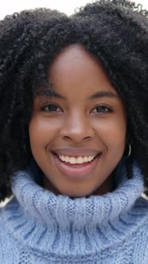 Close Up Of Smiling Woman In Blue Sweater