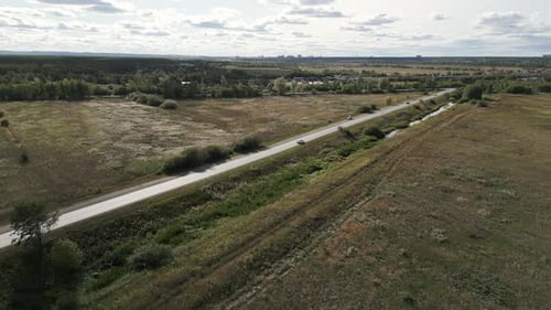 Beautiful Scenic Aerial View of a Rural Road Surrounded By Lush Green Fields and Nature Clip