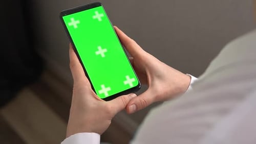 Woman Doctor Holding Green Screen Chroma Key Smartphone Vertical