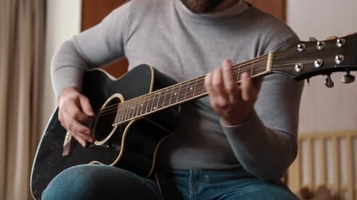Man Playing Black Acoustic Guitar Indoors