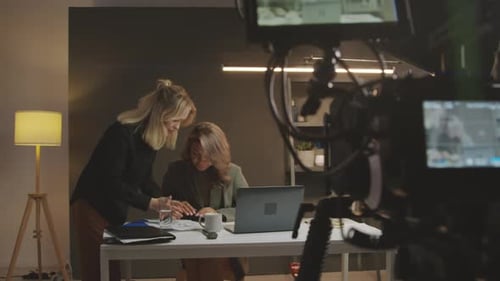 Collaborative Women Working at Desk Filmed Behind Scenes