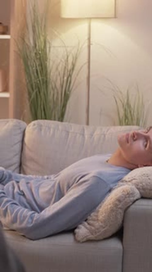Young Man Relaxing on Couch in Living Room