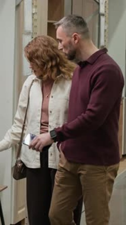 Man and Woman Examining Assortment of Furniture Store