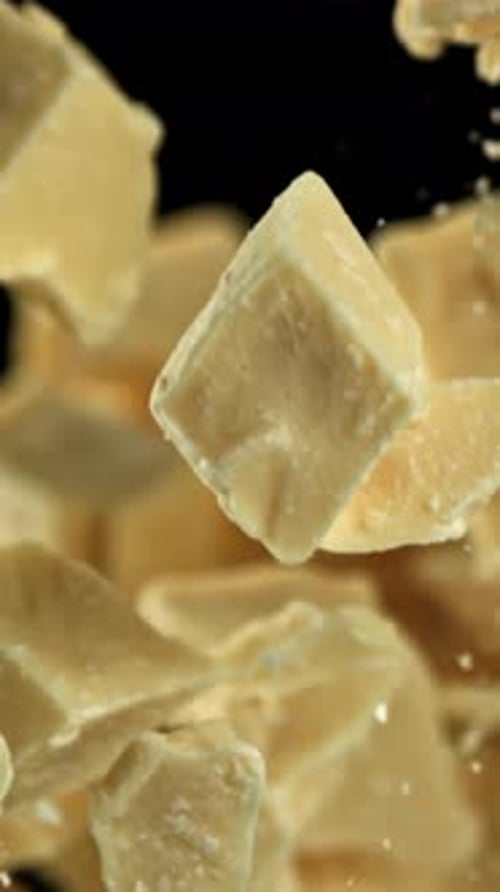 Pieces of White Chocolate Fly Up and Fall Down Filmed on a Highspeed Camera at 1000 Fps