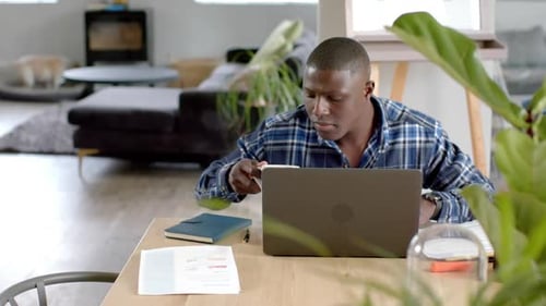 Adult Man Working on Laptop From Home Drinking Coffee