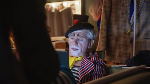 Clown with Makeup Looks at Tablet