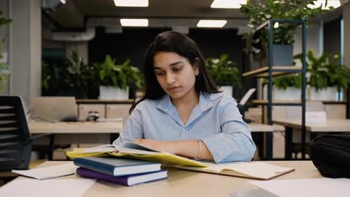 Young Indian Student Preparing for Exams in a University Library