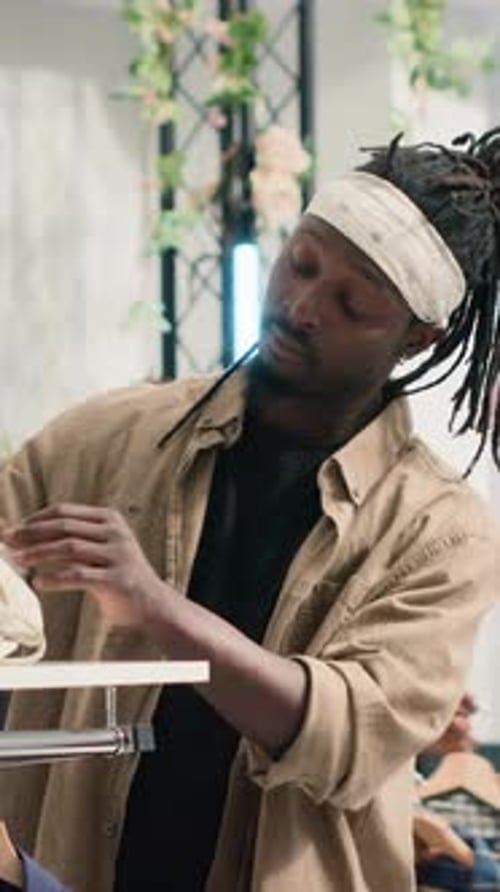 Vertical Video Man Shops in Luxurious Clothing Store